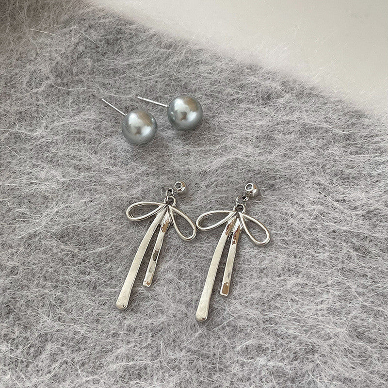 Elegant Niche Bow Earrings for Women: Silver Needle with Pearl Accent